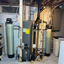A new water softener and water heater installed by Zumbro Valley Plumbing in a basement utility room